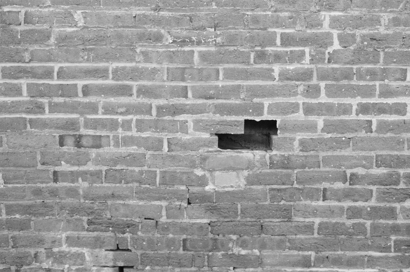 a black and white photo of a brick wall a black and white photo of a brick wall