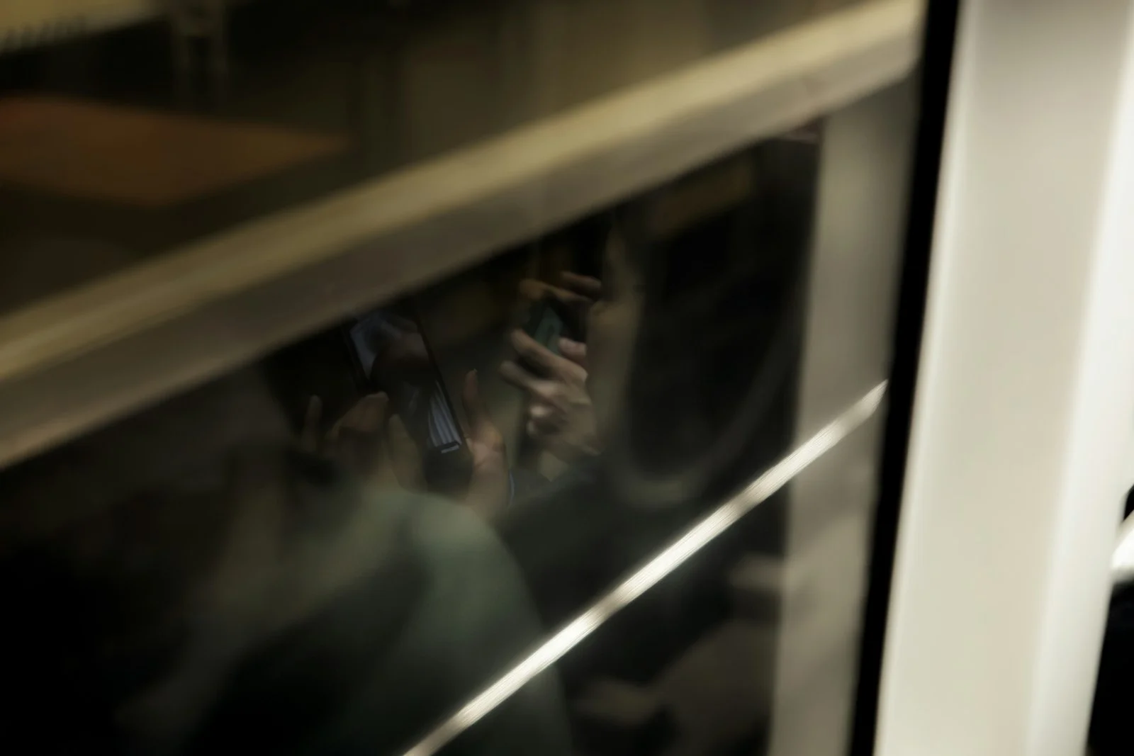 A blurry photo of a person on a cell phone