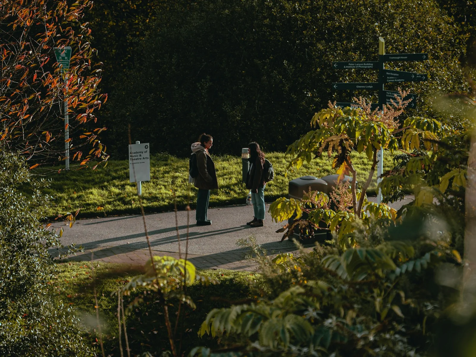 a couple of people that are standing in the grass
