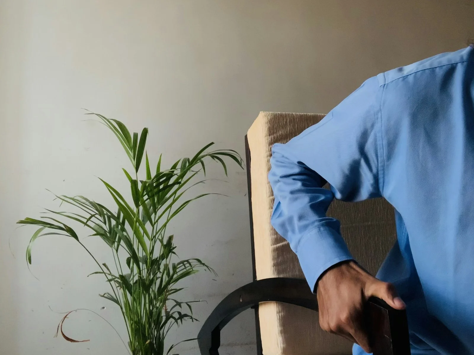 person in blue long sleeve shirt sitting on black chair person in blue long sleeve shirt sitting on black chair