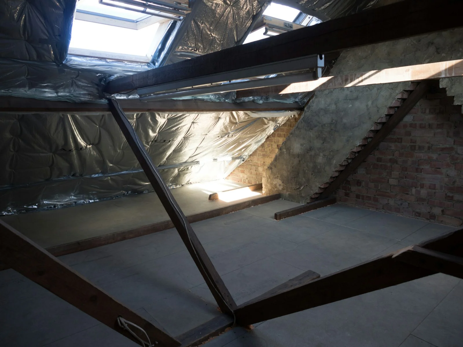 An attic with exposed beams and natural light An attic with exposed beams and natural light