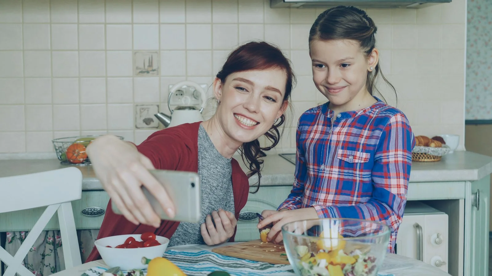 A mother and daughter take a cooking selfie A mother and daughter take a cooking selfie